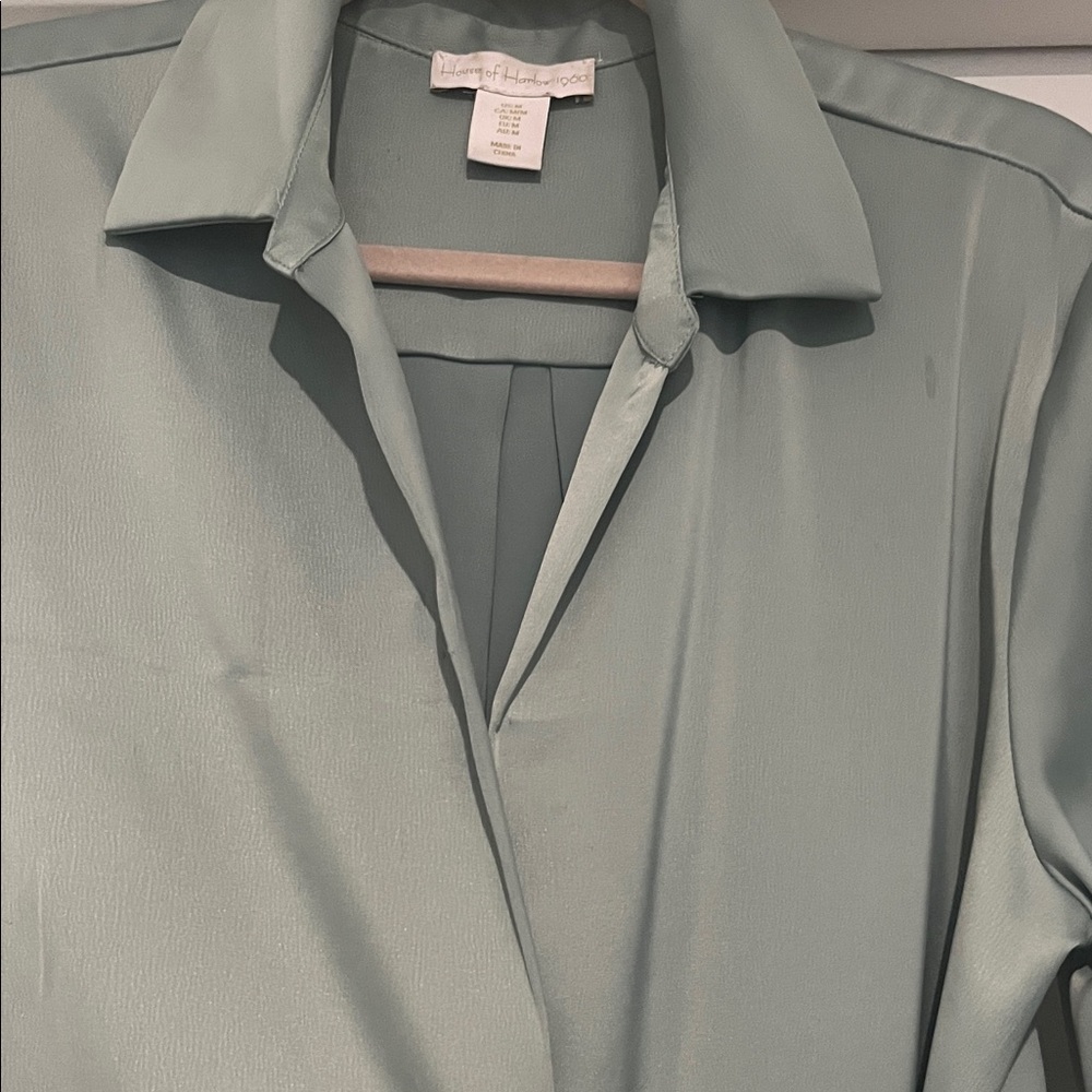 House is Harlow 1960 Light green satin dress cross at waist.